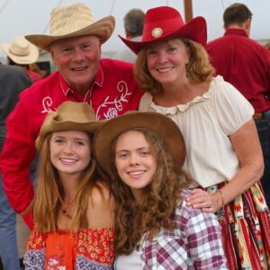 Maddie and her family in Western gear at a Square Dance